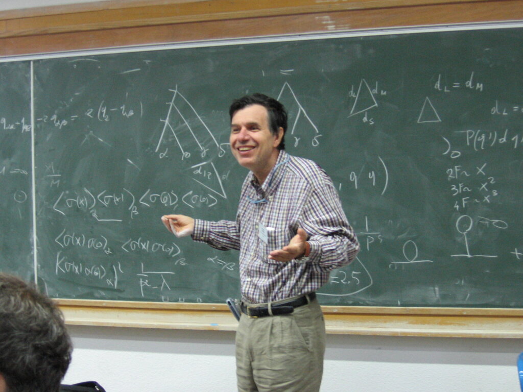 Giorgio Parisi standing in front of a blackboard teaching