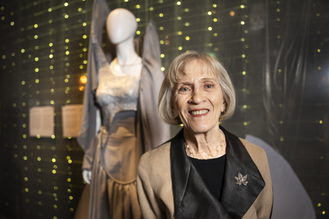 Claudia Goldin in front of a dress inspired by her prize